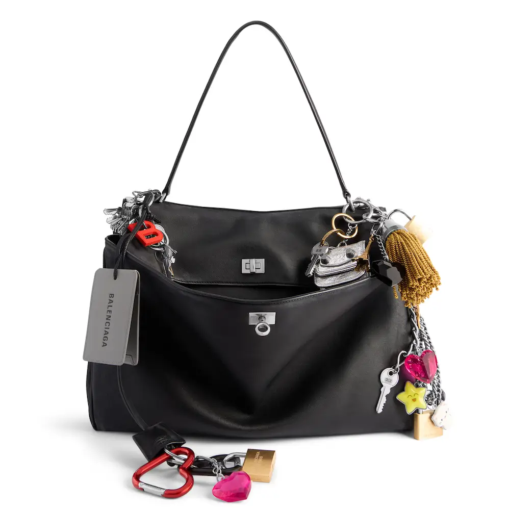 Balenciaga Rodeo Large Handbag in black used smooth calfskin with charms and aged silver hardware is in several looks of Balenciaga Summer 24 Collection